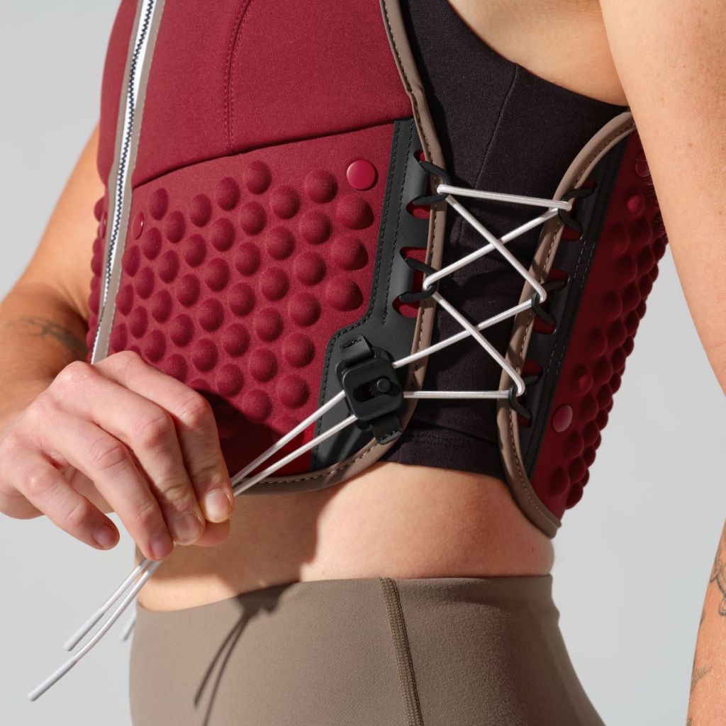 woman adjusting the fit of her G-vest Icon using the elastic side pull cords