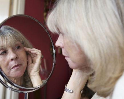 Older woman looking in mirror