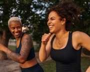 Determined woman competing each other while running at park